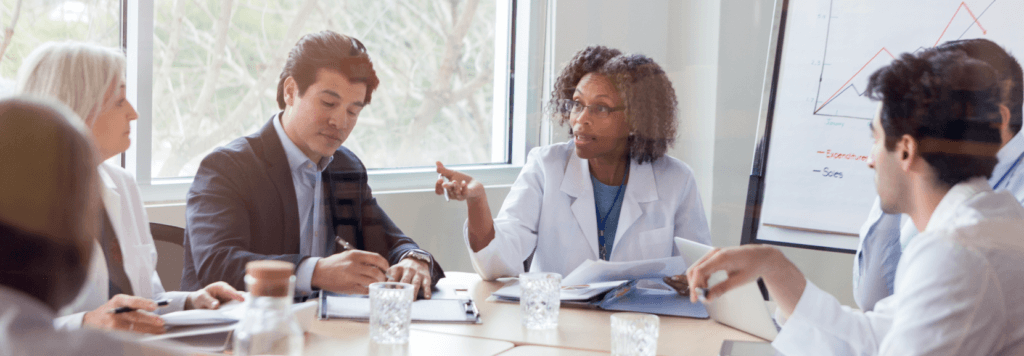 Pharmacy leaders discussing something in a meeting.
