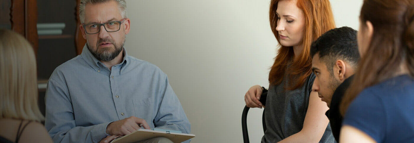 Substance abuse counselor at work with a group of patients.