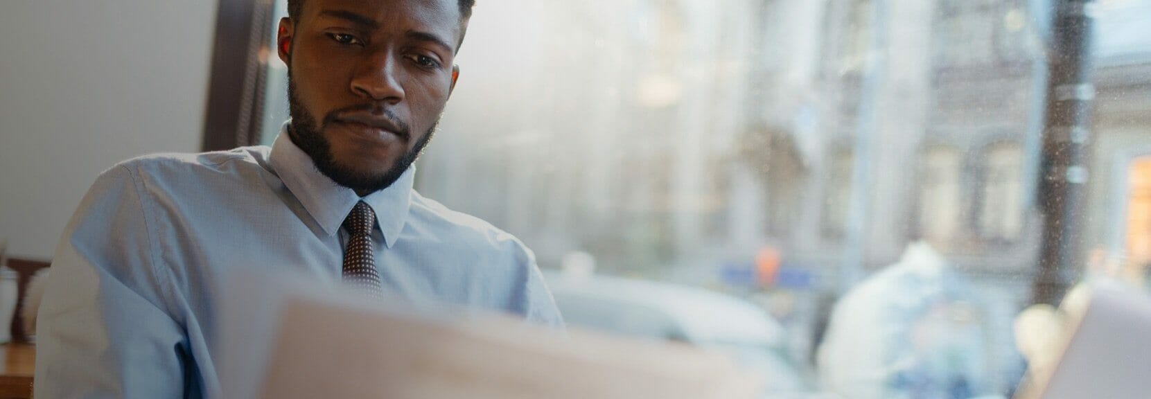 Tax professional analyzing documents in office.