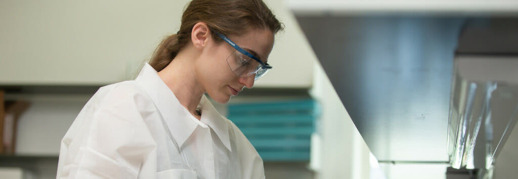 Scientist in lab conducting cosmetic formulation research.