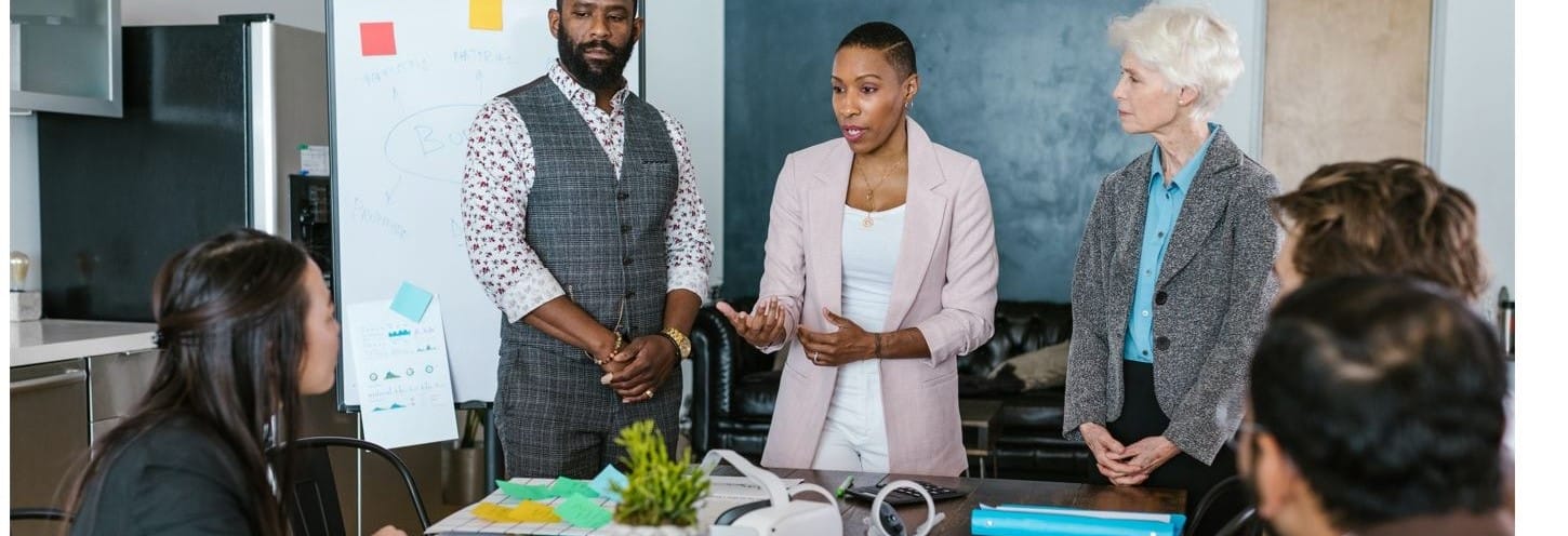 Organizational leadership manager conducting a staff meeting.