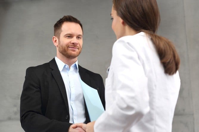 Health Care Administration Graduate student shaking hands with patient 