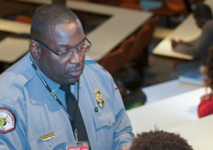 police officer talking to students in classroom