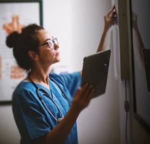 Women's Health Nurse Practitioner examining x-rays