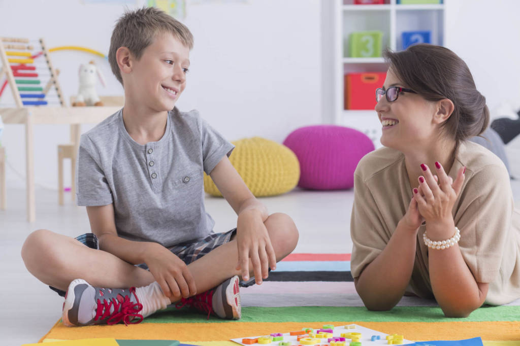 Teacher helping student.