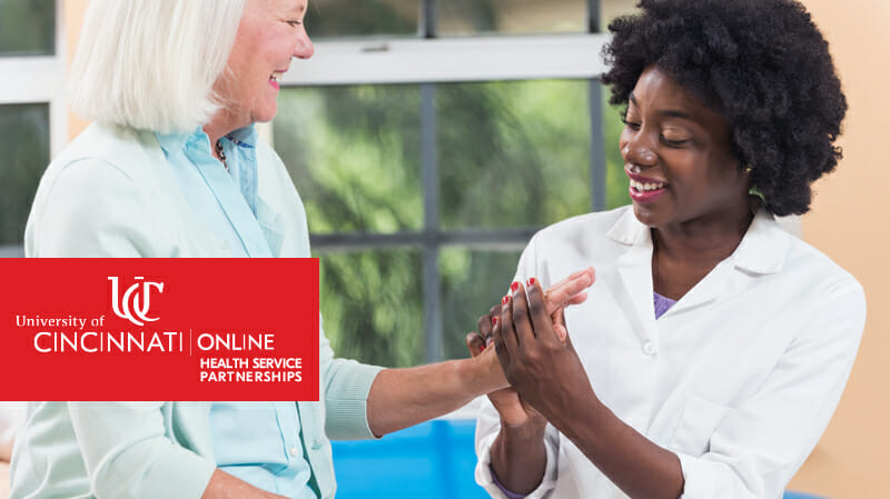 Smiling woman holding hand of another woman