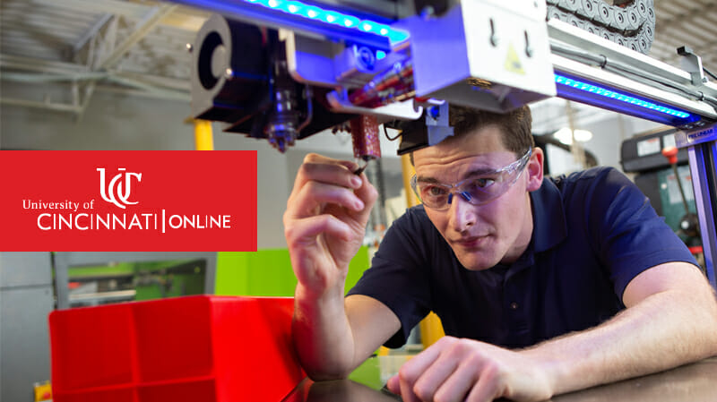 Man with safety glasses tinkering with machine