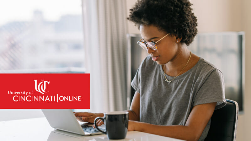 Woman sitting at desk working on laptop