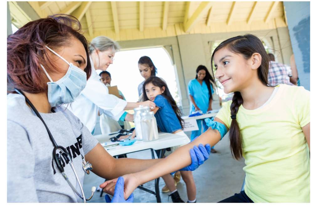 Public Health Worker working with children.