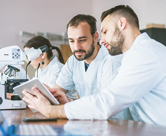 two men looking at tablet