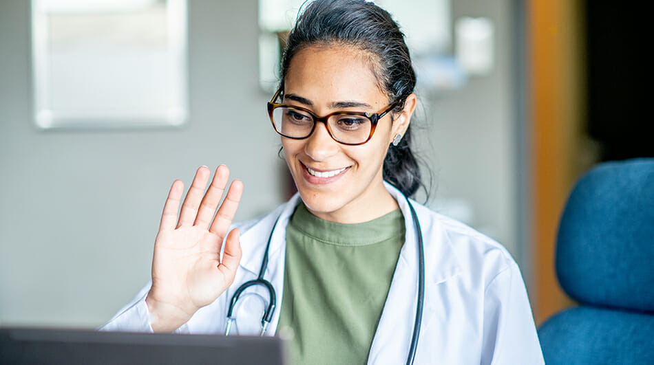 Nurse waving at camera