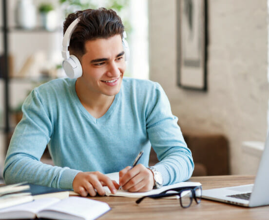 guy studying with headphones on