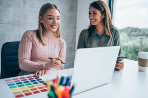 marketing specialist speaking to coworker in office about colors. 