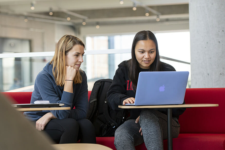 Two girls looking at a computer