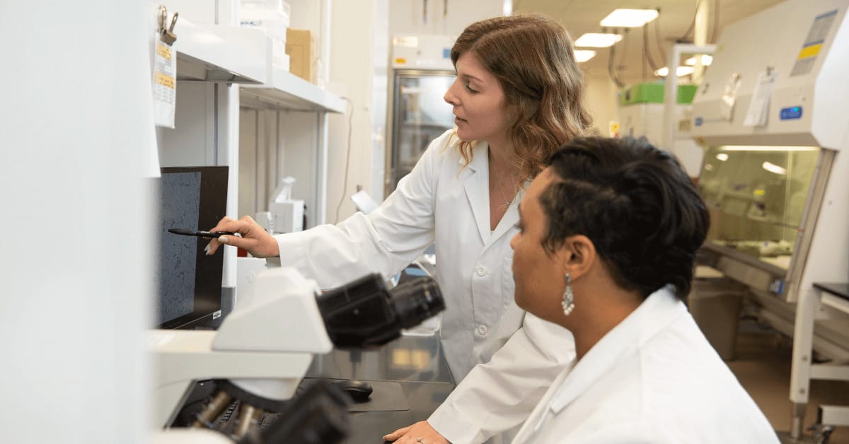 Medical laboratory science leader showing her employee results on a screen
