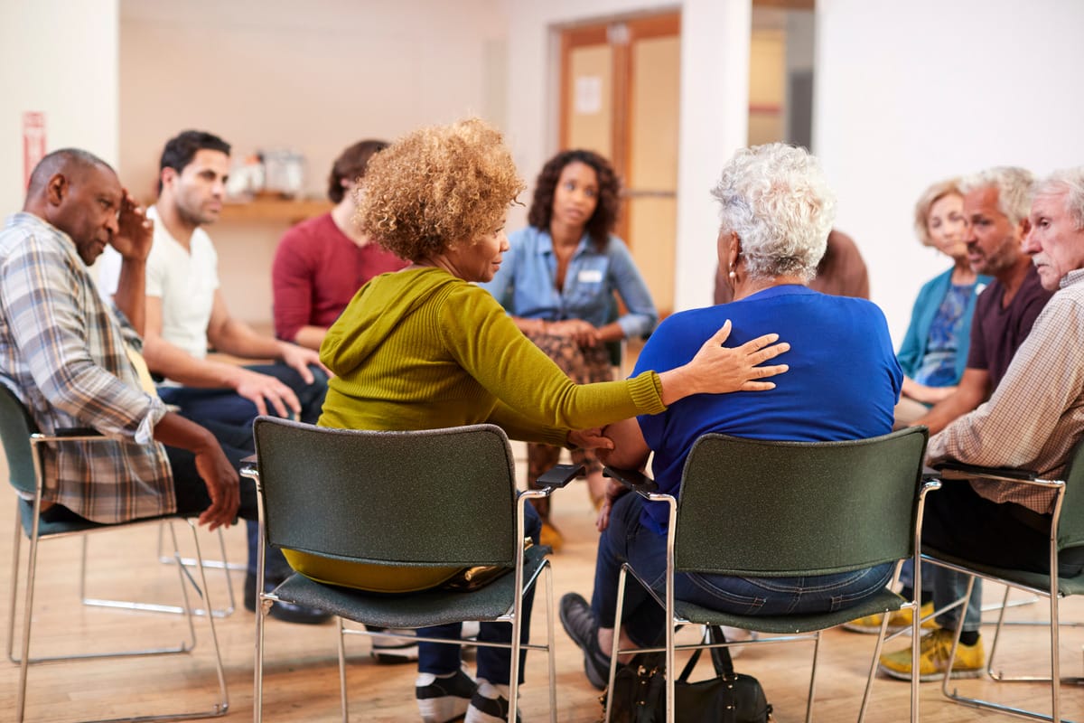 Substance abuse counselor helping group of patients